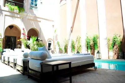 a group of beds sitting outside of a building at Riad Noir d'Ivoire in Marrakech