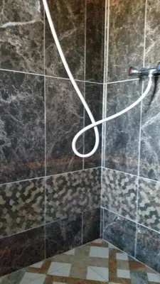 a shower with a hose in a bathroom at Studio meublé proche du centre ville in Marrakech