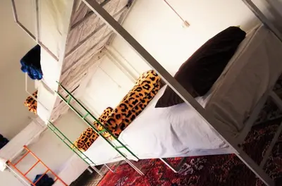 a room with a bed with leopards on it at The Madrassa Hostel in Marrakech