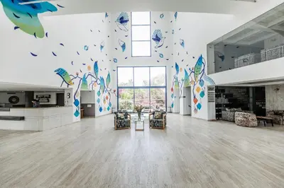 a large room with a large wall with butterflies on it at Wazo Hotel in Marrakech
