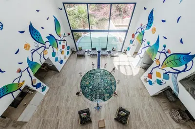an overhead view of a dining room with a table and a mural at Wazo Hotel in Marrakech