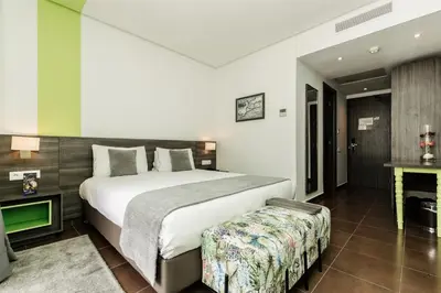a bedroom with a large bed and a table at Wazo Hotel in Marrakech