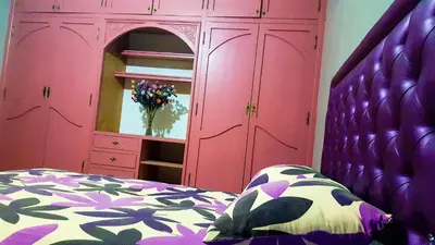 a bedroom with a pink cabinet and a bed at Villa Annakhil in Marrakech