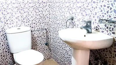 a bathroom with a toilet and a sink at Villa Annakhil in Marrakech