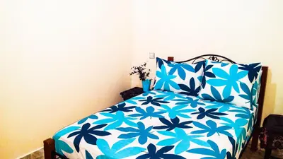 a bedroom with a blue and white bed with pillows at Villa Annakhil in Marrakech