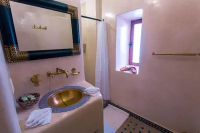 a bathroom with a gold sink and a mirror at Riad Chams Marrakech in Marrakech