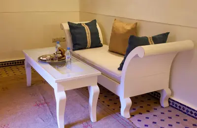 a living room with a couch and a table at Riad Chams Marrakech in Marrakech