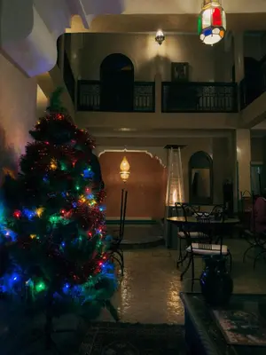 a christmas tree in a living room with a table at Riad Lapis-lazuli in Marrakech