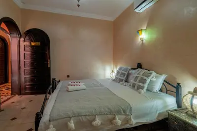 a bedroom with a large bed with pillows on it at Riad Haj Thami in Marrakech