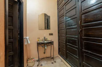 a bathroom with a sink next to a door at Riad Haj Thami in Marrakech