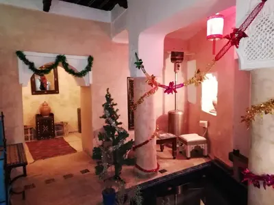 a living room with a christmas tree and a fireplace at Riad Sabbah in Marrakech