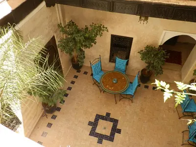 an overhead view of a patio with a table and chairs at Riad Sabbah in Marrakech