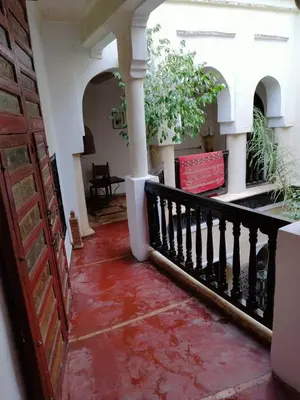 a hallway of a house with a red floor at Riad Sabbah in Marrakech