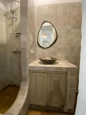 a bathroom with a sink and a mirror at Private house Riad Arlette exclusive in Marrakech