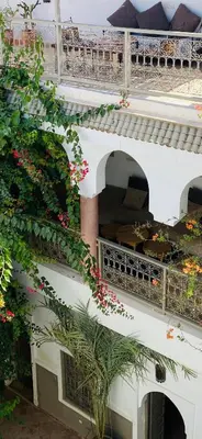 a white building with flowers on the side of it at Private house Riad Arlette exclusive in Marrakech