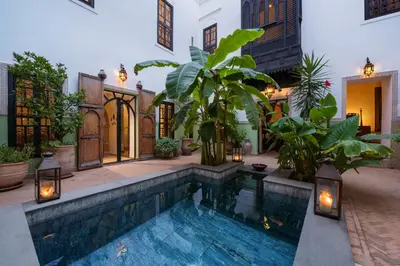 a pool in the middle of a house with plants at Riad Azzar in Marrakech