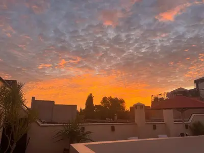 a view of a sunset from a rooftop at Riad Azzar in Marrakech