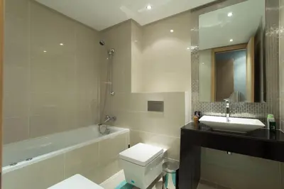a bathroom with a toilet and a sink and a tub at Prestigia 16 in Marrakech