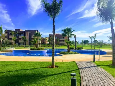 a resort with a swimming pool and palm trees at Prestigia 16 in Marrakech