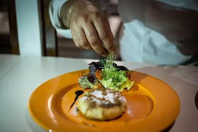 a person eating a plate of food on a table at Riad Challa Hotel & Spa in Marrakech