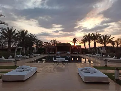 a resort with two beds in front of a pool at Dar Sofil - Adults Only in Marrakech