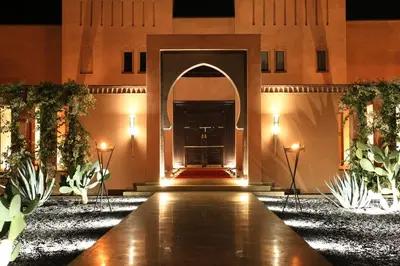 a hallway with an arch in a building with plants at Dar Sofil - Adults Only in Marrakech