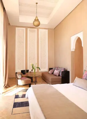 a bedroom with a bed and a couch in a room at Dar Sofil - Adults Only in Marrakech