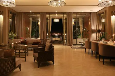 a lobby with tables and chairs and a living room at Dar Sofil - Adults Only in Marrakech