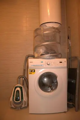 a washing machine with a bag on top of it at Prestigia Golf City Apartment in Marrakech