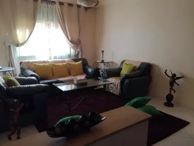 a living room with a couch and a table at Kim Apartment in Marrakech