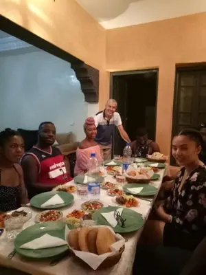 a group of people sitting around a table with food at Riad Abjaou in Marrakech