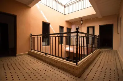 a room with a balcony with a skylight at Riad Abjaou in Marrakech