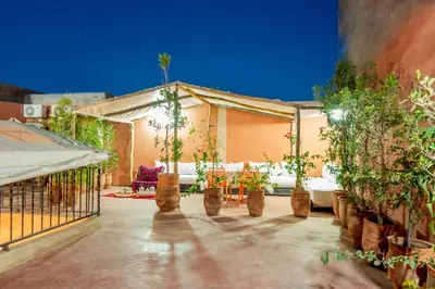 a patio with potted plants and a fence at Riad Abjaou in Marrakech