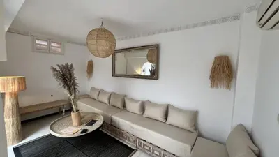 a living room with a couch and a mirror at Riad Sarah Sabrina in Marrakech