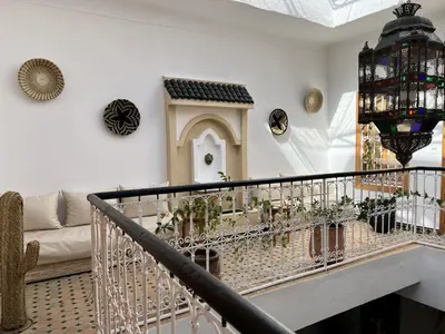 a living room with a staircase with plants on it at Riad Sarah Sabrina in Marrakech