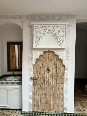 a large wooden door in a room at Riad Sarah Sabrina in Marrakech