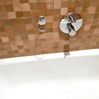 a bathroom sink with a faucet on a tiled floor at Comfortable Apartment in Marrakech with Shared Pool, 124 sqm in Marrakech