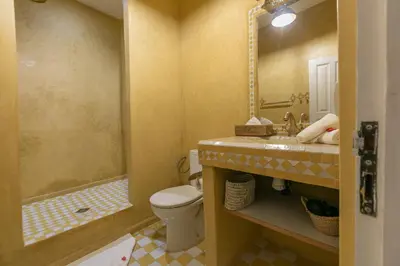 a bathroom with a toilet and a sink and a shower at Riad Zeitoun Palace in Marrakech