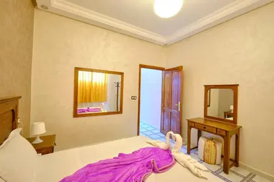 a bedroom with a bed and a mirror at Hotel Central Palace in Marrakech