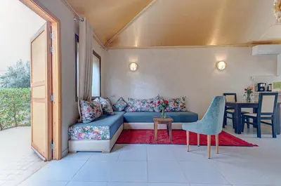 a living room with a blue couch and a table at Ferme Sidi Safou & Spa in Marrakech