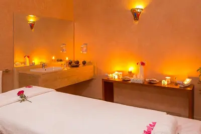 a bathroom with a bed and a sink and a mirror at La Palmeraie De L'Atlas in Marrakech
