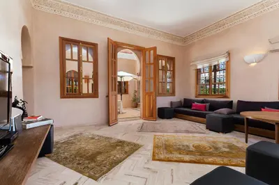 a living room with a couch and a table at La Palmeraie De L'Atlas in Marrakech