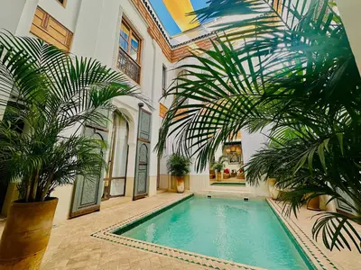 an indoor swimming pool in a house with palm trees at Riad Jardin Des Sens & Spa in Marrakech