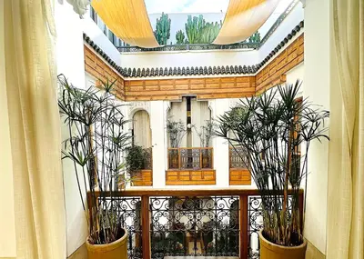 a balcony with three potted plants and a skylight at Riad Jardin Des Sens & Spa in Marrakech