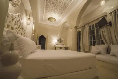 a bedroom with a white bed and a window at Riad Palais Blanc & Spa in Marrakech