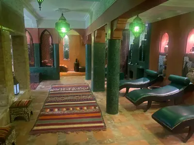 a lobby with chairs and a rug on the floor at Riad Palais Blanc & Spa in Marrakech