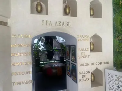 an entry way to a building with signs on the wall at Riad Palais Blanc & Spa in Marrakech