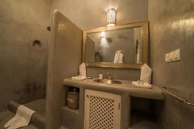 a bathroom with a sink and a mirror at Riad Palais Blanc & Spa in Marrakech