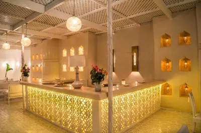 a lobby with a lit up counter with lights at Riad Palais Blanc & Spa in Marrakech