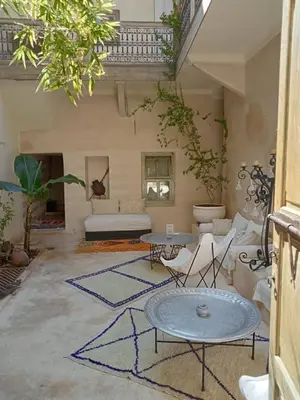 a living room with two tables and a couch at Dar al Sultan in Marrakech
